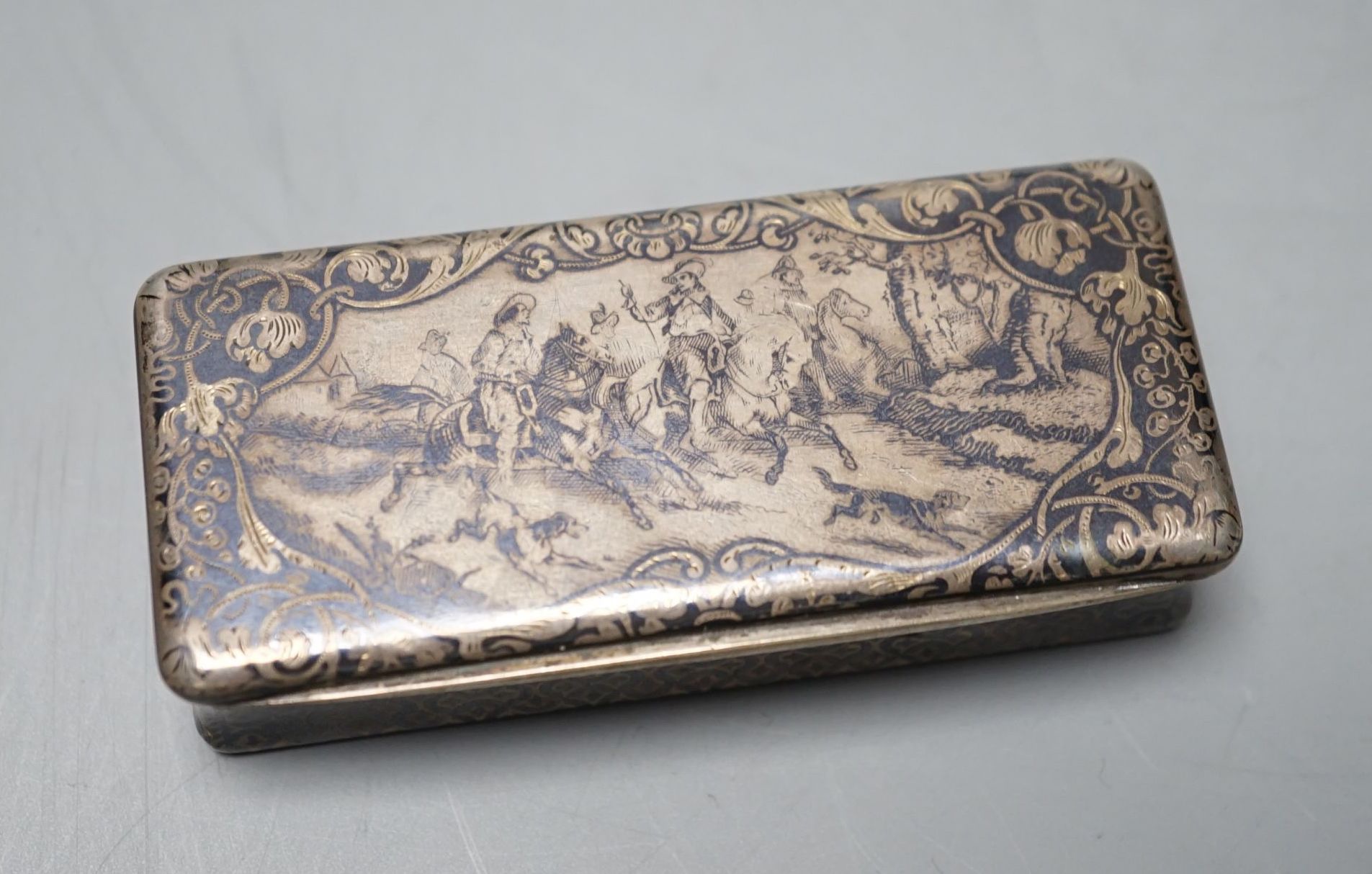 A 19th century French white metal and niello snuff box, decorated with hunting scene, 78mm.